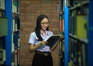 student in library